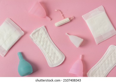 Different types of feminine menstrual hygiene materials products such as pads cloths tampons and cups. Pink background. Menstruation and feminine hygiene concept. Stock Photo