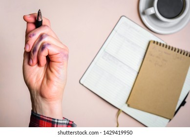 Dirty left hand after writing. Left hander day concept. Working place of lefty Stock Photo