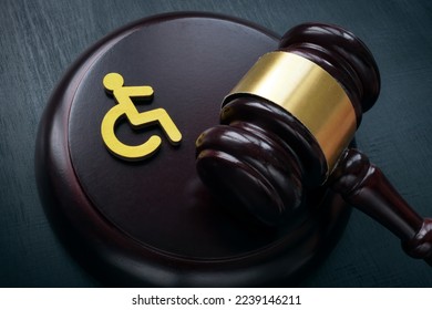 Disabled person sign and gavel. Accessibility law concept. Stock-foto