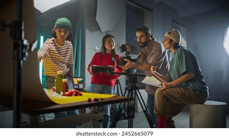 Diverse Young Filmmakers Collaborate On A Vibrant Set, Focusing On A Camera Setup While Discussing Scene Details, Reflecting Creativity And Teamwork In Modern Videography And Advertising Production. Arkistovalokuva