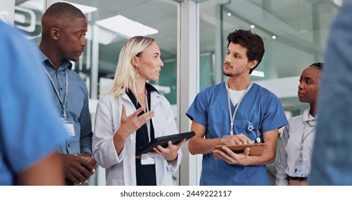 Doctors, group and meeting on tablet for medical planning, advice and support in teamwork or hospital solution. Healthcare staff, people and leader on digital technology and talking of clinic results Stockfoto