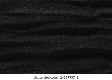 Dunes of dark black sand. Stripes and ripples of smooth volcanic sand texture or wallpaper. Wave pattern in black sand background.: zdjęcie stockowe