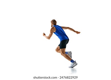 Dynamic image of man in a run, runner in motion, training isolated on white studio background. Speed and endurance. Concept of sport, marathon, competition, healthy and active lifestyle Arkistovalokuva