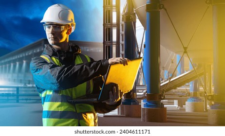 Energetics plant under. Innovations power industry. Engineer stands among hydrogen equipment. Mechanic with laptop controls process of obtaining energy. Storage h2 库存照片