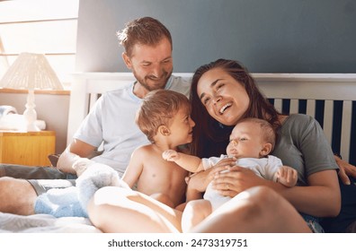 Family, parents and children in bed of home, relax and weekend in bedroom. Cuddle, support and mother person with father for love and childhood development, kid and smile for care and happiness Stockfoto