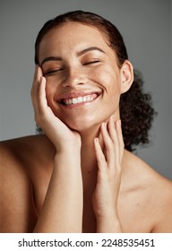 Face, beauty and skincare with a model black woman in studio on a gray background to promote natural care. Facial, wellness and makeup with an attractive young female happy with her skin product Foto stock