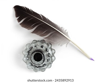 Feather with a vintage glass bottle of ink. Feather for calligraphy, old education, vintage fonts. Top view. Stock-foto