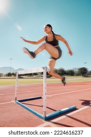 Fitness, hurdle and woman running in stadium track for training, health and sports workout. Exercise. cardio and endurance with strong girl runner and jump for power, performance and competition Foto stock