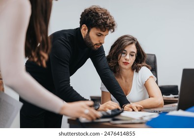 Focused professionals collaboratively working at a modern office desk, teamwork in business. Adlı Stok Fotoğraf