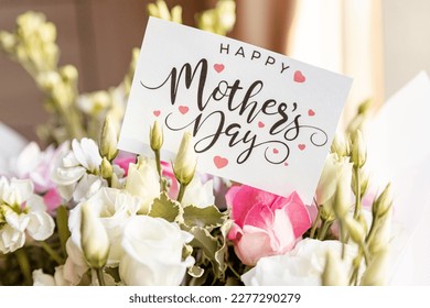 flower composition of light roses and eustoma closeup. Text Happy mother's day. Bright bouquet with tender flowers.Greetings card,sweet wish concept. Stock Photo