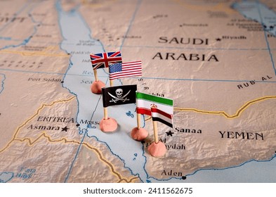 Flags of the United States and Iran and their respective allies surrounding a pirate insignia onto a map of the Red Sea region. It symbolically represents the intricate geopolitical dynamics and Foto stock