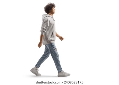Full length portrait of a tall guy with curly hair walking isolated on white background: stockfoto
