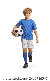 Full length portrait of a boy in a football kit walking and carrying a ball isolated on white background Foto stock