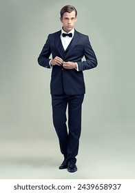 Gentleman, studio and portrait with rich, vintage and class for retro style and fashion. Man, spy or agent with tuxedo, suit and luxury with confidence for black tie isolated on white background 库存照片