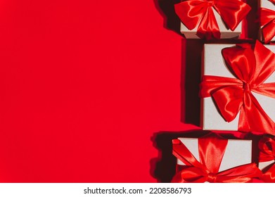 Gorgeous festive Christmas banner or header, holiday presents on red background. Christmas gift boxes on red. Holiday season, New Year. Copy space for text. Stock Photo
