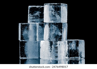 A group of three ice cubes, isolated on a black background. 库存照片