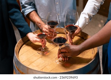 Group of Professional sommelier tasting and smelling red wine in wine glass at wine cellar with wooden barrel in wine factory. Winery liquor manufacturing industry and winemaker business concept. – Ảnh có sẵn