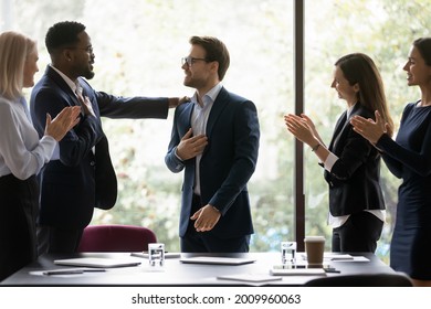 Grateful diverse team expressing recognition, appreciation, acknowledge to leader, clapping hands, touching shoulder, congratulating boss on achieve, good work result, applauding promoted coworker Arkistovalokuva