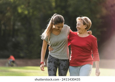 Granddaughter and grandmother having fun- jogging together in the park Stock-foto