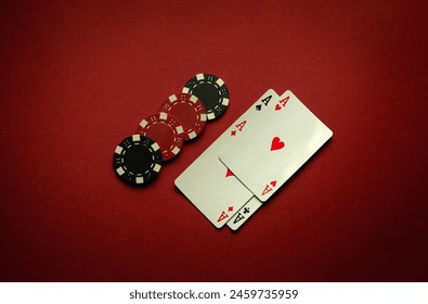 Great luck in the card game of poker with a winning combination of four of a kind or quads. Playing cards aces and chips are laid out in a club on a red table. ภาพถ่ายสต็อก