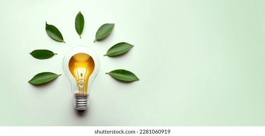 Green Energy Concepts. Wireless Light Bulb surrounded by Green Leaf as Sign of Light On. Carbon Neutral and Emission ,ESG for Clean Energy. Sustainable Resources, Renewable and Environmental Care Stock Photo