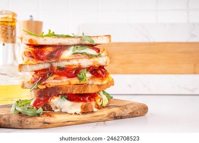 Grilled Pizza Sandwich, cheese pizza burger with tomatoes, tomato sauce, bacon, pepperoni salami, arugula, copy space Stock-foto