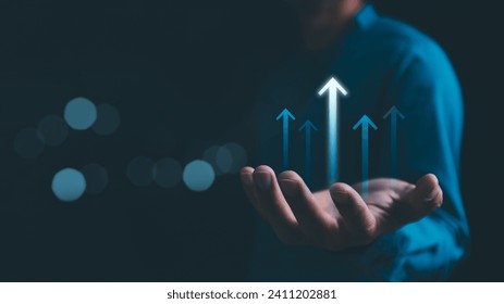Hand holding growth business strategy arrow concept on success target improvement with increase development graph profit or economy investment income target and goal increase achievement. Stockfoto