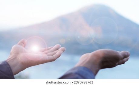 Hand receive light background. With open hands gesture of person on top mountain soft blue color backgrounds. Spirituality concepts, God blessings. Foto stock