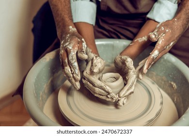 Hands of two people making a new pottery product together 庫存照片