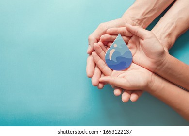 Hands holding clean water drop,world water day,hand sanitizer and hygiene, vaccine for covid, family washing hands, CSR, save water, clean renewable energy, drop of life mental health concept  Stock Photo
