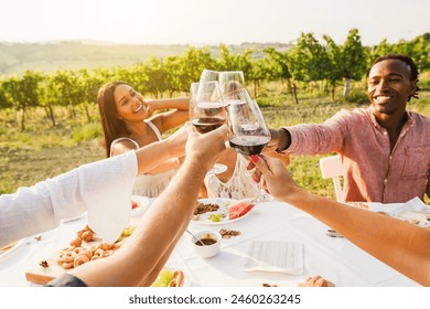 Happy adult friends having fun drinking red wine and eating together with vineyard in background - Multiracial people doing appetizer at summer time in countryside resort - Focus on bottom hands – Ảnh có sẵn