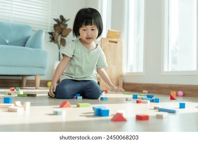 Стоковая фотография: Happy Asia children play and learn toy blocks.family is happy and excited in the house. daughter having fun spending time, Activity, development, IQ, EQ, meditation, brain, muscles, essential skills.