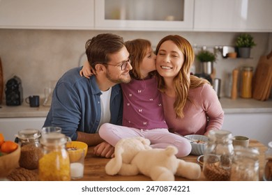 Happy family having breakfast at table in kitchen  – Ảnh có sẵn