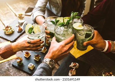 Happy friends group cheering mojito drinks at cocktail bar restaurant - Young people having fun drinking cocktails on happy hour at pub - Party time and youth concept	
 स्टॉक फोटो