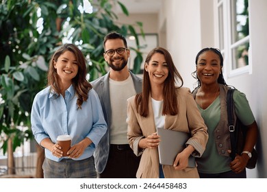 Happy multiracial group of creative business people in the office looking at camera. Foto stock