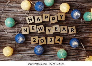 Happy New Year 2024 decorate with LED cotton ball on wooden background स्टॉक फोटो