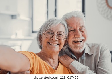 Стоковая фотография: Head shot portrait happy senior couple taking selfie, having fun with phone cam, smiling aged wife and husband hugging, looking at camera, posing for photo, aged man vlogger recording video