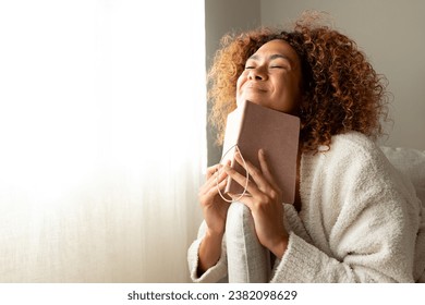 Hispanic female making wish in personal journal. Multiracial woman feeling happy and grateful after writing in manifesting diary. Copy space. Lifestyle concept. - Φωτογραφία στοκ