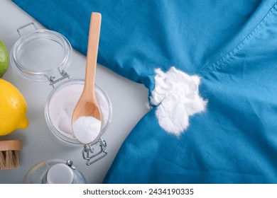 Homemade cleaning sweat stains the armpits on a T-shirt. Eco-friendly cleaning products white vinegar, baking soda, lemon. Embracing a zero-waste lifestyle. High quality photo 库存照片