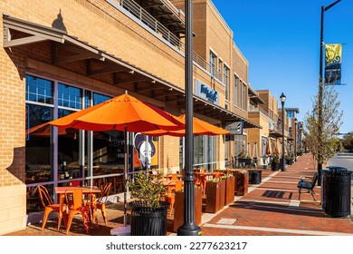 Holly Springs, North Carolina USA-03 19 2023: View of Red Brick Sidewalk in Downtown Holly Springs from the Sir Walter Coffee Shop. The Sidewalk is Deserted on Sunday Morning. 報導類庫存照片