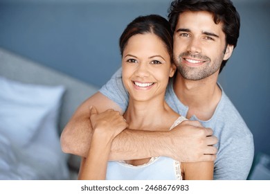 Hug, portrait and trust with couple in bedroom of home together for bonding, marriage or support. Face, love or smile with happy man and woman in apartment to relax for morning or weekend time off Stock-foto