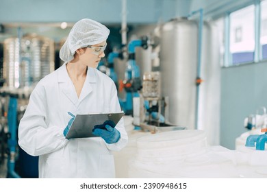 hygiene staff worker in foods and drinks clean factory. working women in water plant industry quality control check. Stock fotografie