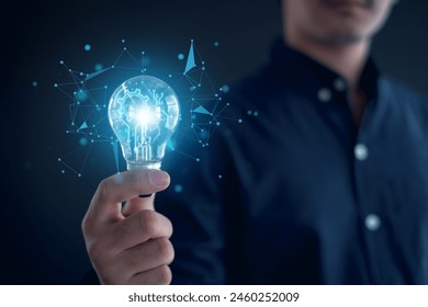 Idea innovation and inspiration concept.Hand of man holding illuminated light bulb, Idea innovation and inspiration concept.  creativity with bulbs that shine glitter, Concept for success. Arkistovalokuva