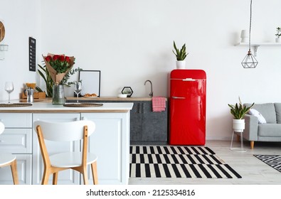 Interior of modern kitchen with counters and red fridge Stock Photo