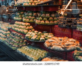 Istanbul. Turkish sweets in a grocery store window: a variety of baklava with pistachios and walnuts. Traditional Middle Eastern tastes. Assorted traditional Turkish desserts. No people Arkistovalokuva
