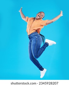 Jump, black woman and excited portrait with motivation in studio from celebration smile. Happy, energy and African female person with promotion and blue background with leap from deal announcement