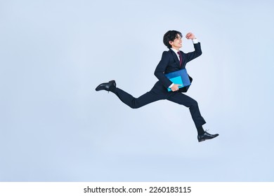 Jumping young businessman. Challenge of business. Foto stock