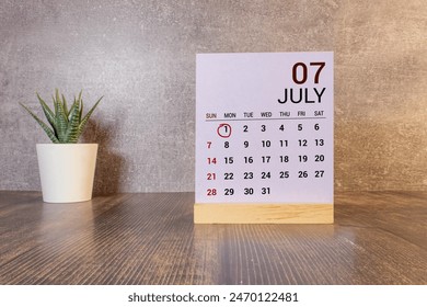 July 1st. Image of july 1, close-up wooden color calendar on yellow background. Summer day. Foto stock