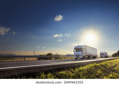 Large Transportation Truck on a highway road through the countryside at sunset – Ảnh có sẵn