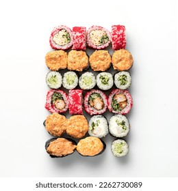 Large set of different types of sushi rolls. Rolls baked, rolls with caviar, rolls with avocado. Japanese food. Seafood dishes. View from above. Isolate on white background. Copy space.  库存照片